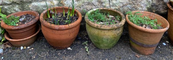 Four terracotta plant pots, each approx. 25cmH, various shapes