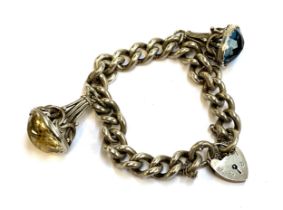 A silver curb link bracelet with heart shaped padlock, with two fob charms, one set with citrine,