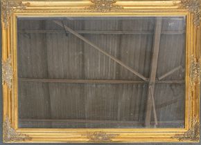 A gilt gesso rectangular wall mirror with bevelled plate, 104x74cm