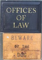 Two signs 'Beware of the Dog' and 'Offices of Law'
