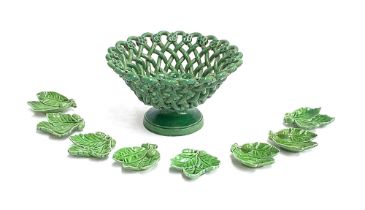 A green glazed continental basket, 20cmD; together eight green glazed acorn leaf shaped pin