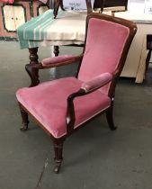 A 19th century rosewood open armchair, on turned legs with brass casters, 61cmW