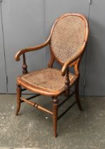 A Thonet style open armchair, caned back and seat, 57cmW, the seat 40cmH