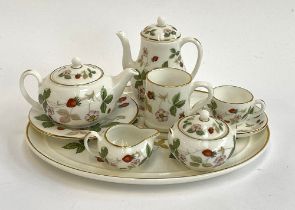 A Wedgwood Wild Strawberry miniature dolls tea set, comprising teapot, coffee pot, milk jug, sugar