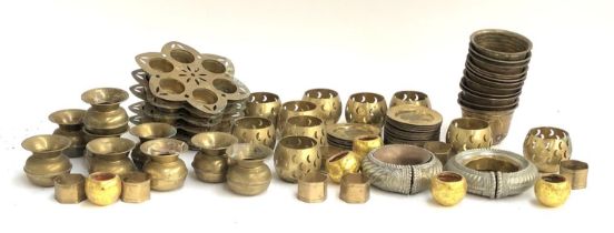 A quantity of brass candle holders, ashtrays and napkin rings