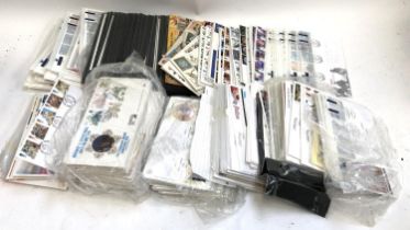 A large quantity of first day covers, together with a small quantity of stamps