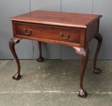 A side table in 18th century style, with single drawer, on acanthus carved cabriole legs on ball and