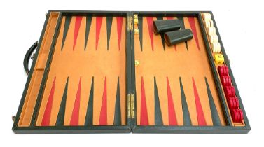 A cased backgammon set, leather lined