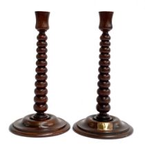 A pair of bobbin turned candlesticks, made from wood from the HMS Lion, bears plaques, 30cmH
