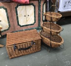 A wicker hamper, 58cmW; together with a three tier wicker vegetable stand, 80cmH