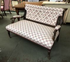 An early 20th century button back two seater sofa, with carved mahogany frame, well stuffed seat, on