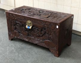 A carved camphorwood chest with brass padlock, 76cmW