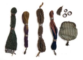 A lot of four 19th century misers purses; together with a Regency blue silk coin purse with Silesian