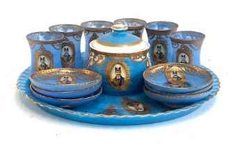 A Persian gilt and blue glass tea set depicting a ruler; together with three Sumerbank teacups and