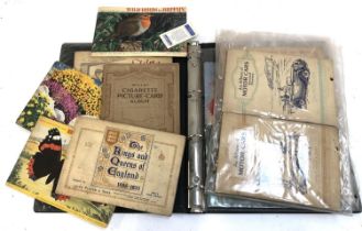 A quantity of cigarette and tea cards stuck in albums to include Typhoo, Players, Wills etc