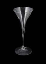 A plain stemmed toasting glass, of drawn trumpet form with conical foot