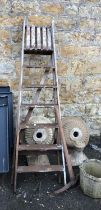 A vintage wooden seven rung stepladder, together with a vintage pickaxe