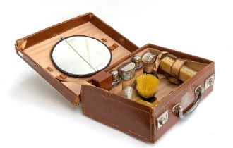 A gents overnight vanity case containing various plated bottles and canisters (af), 35cmW