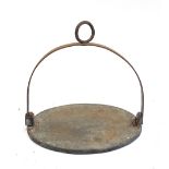 A heavy cast iron swing skillet, 31cmD, the iron approx. 3/8" thick