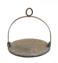 A heavy cast iron swing skillet, 31cmD, the iron approx. 3/8" thick