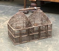 A wrought metal double bird cage, 48x25x34cmH