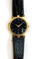 A Gucci ladies watch model 3400 FM, gold tone with black dial and leather strap