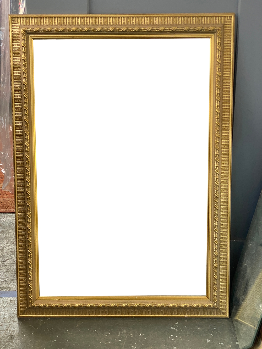 A large gilt framed rectangular mirror with bevelled glass, 107x76cm