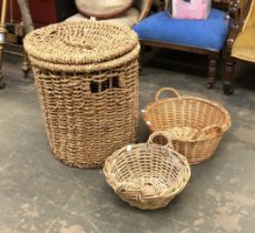 A large rush lidded laundry basket, 56cmH; together with two wicker baskets