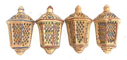 Interior design interest: a set of four glazed terracotta pierced candle holders/walls scones, 39cmH