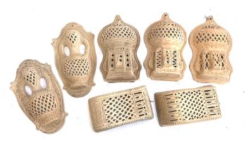 Interior design interest: seven Moroccan style terracotta pierced wall candle holders/sconces,