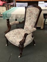 A 19th century open armchair, turned legs and ceramic casters, 74cmH