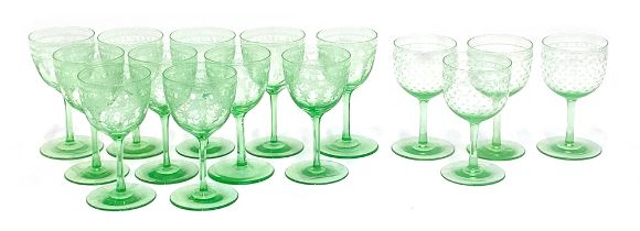A set of 11 green tint wine glasses with etched decoration, 12.5cm high; together with a further