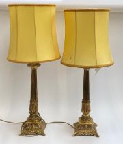 A pair of gilt metal column table lamps with shades, 50cmH to base of fitting