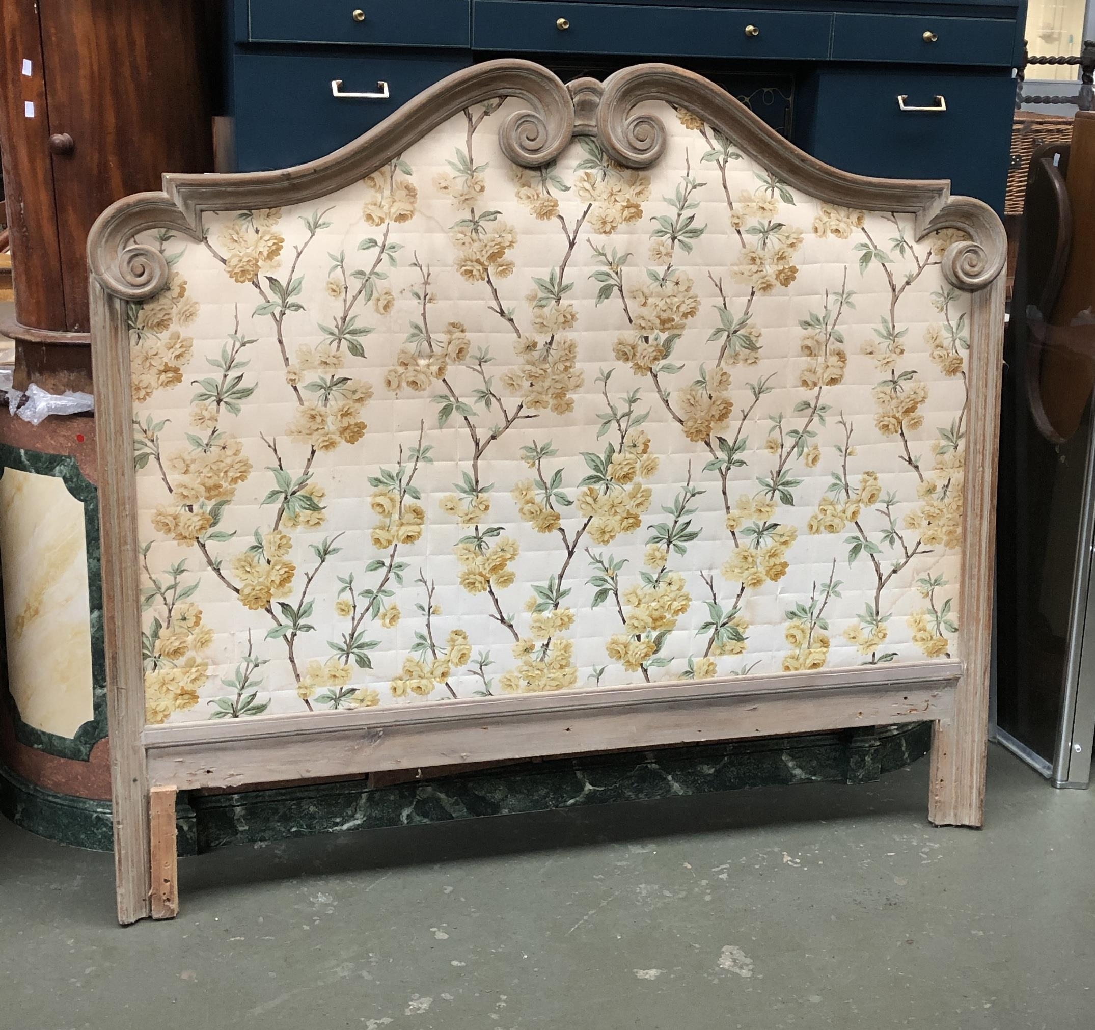 A carved wooden upholstered king sized headboard, 157cmW 140cmH