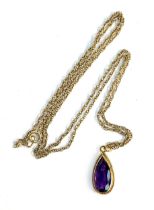 A 9ct gold mounted amethyst teardrop shaped pendant, hallmarked for Birmingham 1975, 1.9cmL, on a