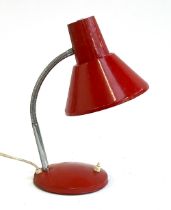 A mid century red desk lamp