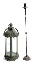 A metal hexagonal lantern, 51cmH; together with a metal candlestick, 77cmH