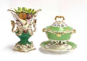 A 19th century porcelain lidded tureen and stand, hand painted with flowers, heightened in gilt,