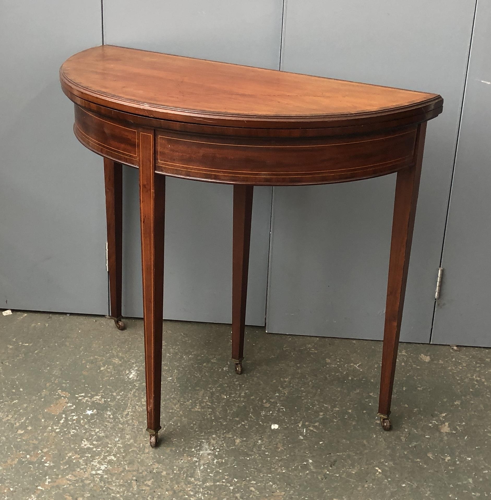 A 19th century demilune card table, on square tapered legs with casters, 84x42x74cmH