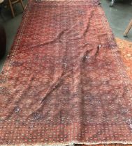 A large red ground rug, significantly worn, 358x185