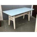 A 20th century kitchen table, the top painted a pale blue, on a white painted trestle base,