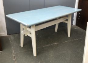 A 20th century kitchen table, the top painted a pale blue, on a white painted trestle base,