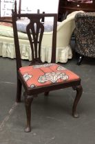 An 18th century mahogany splatback side chair with drop in seat, on carved cabriole legs with pad
