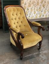 A 19th century mahogany button back open armchair, on turned legs and casters; together with