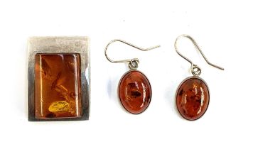 A modernist 925 silver and amber pendant, 3cmL; together with a matching pair of silver and amber