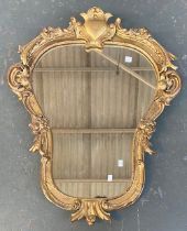 A Rococo style shaped wall mirror, in a gilt painted carved gesso frame, 80x65cm; together with a