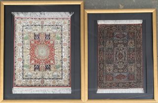 Two framed and glazed miniature silk Persian sample rugs, the larger 50x39cm, the smaller 46x30cm