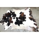 A large cowhide rug, approx 244x229cm
