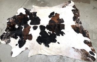 A large cowhide rug, approx 244x229cm