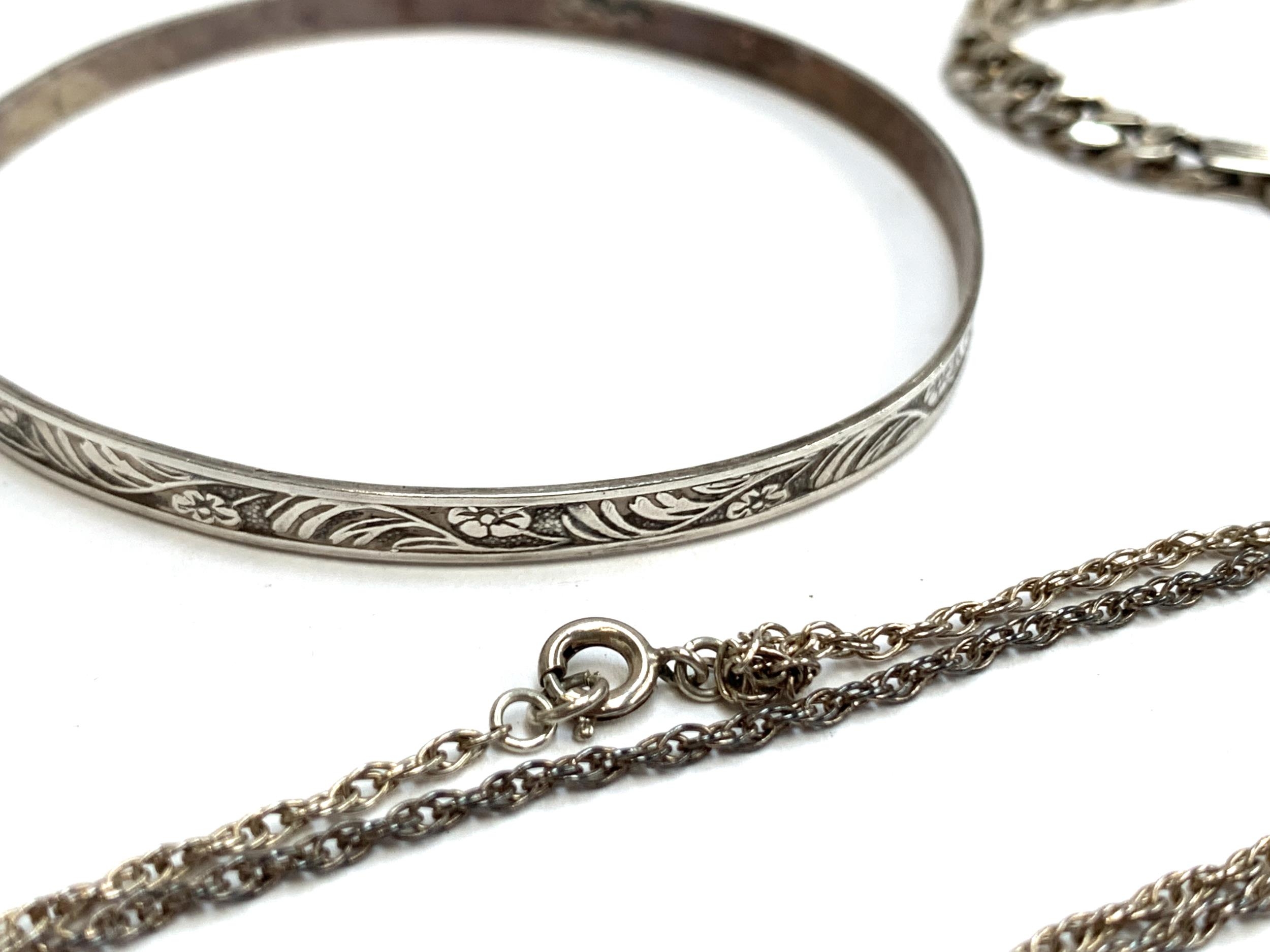 A quantity of silver chains, bangle and a bracelet, gross weight 42g - Image 2 of 2